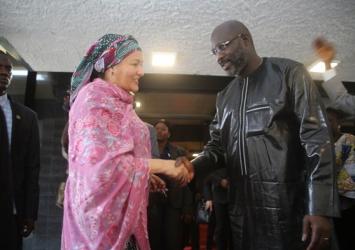 Madame Amina Mohammed shakes hand with President WeahExecutive Mansion Photo