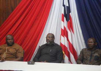 President Weah Speaking to Students As Press Secretary and Security Adviser Listen.EXECUTIVE MANSION