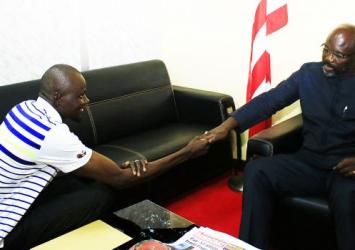 President Weah shakes hand with Mamoudou Toure in his office.EXECUTIVE MANSION